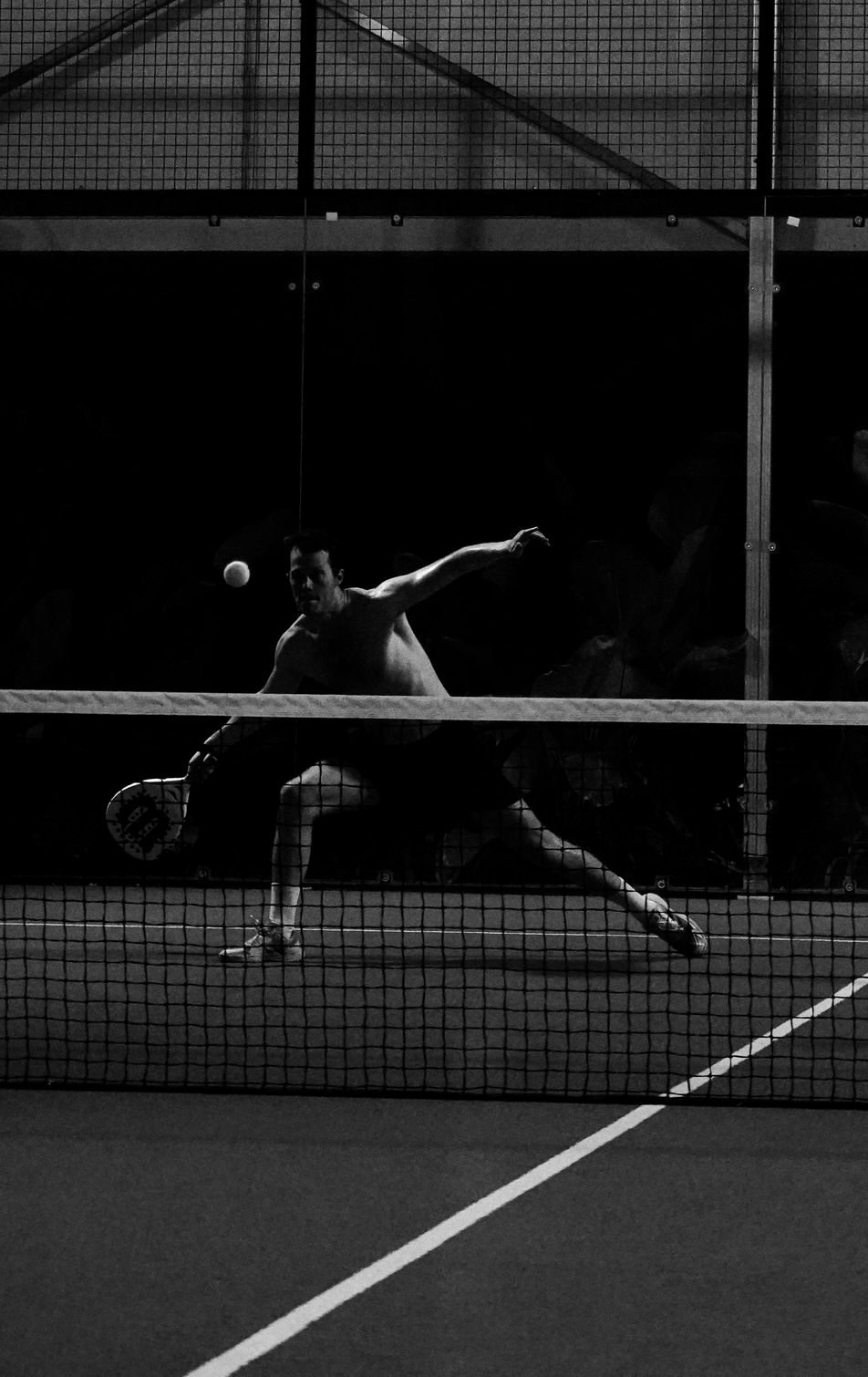 A player hitting the ball in a night match