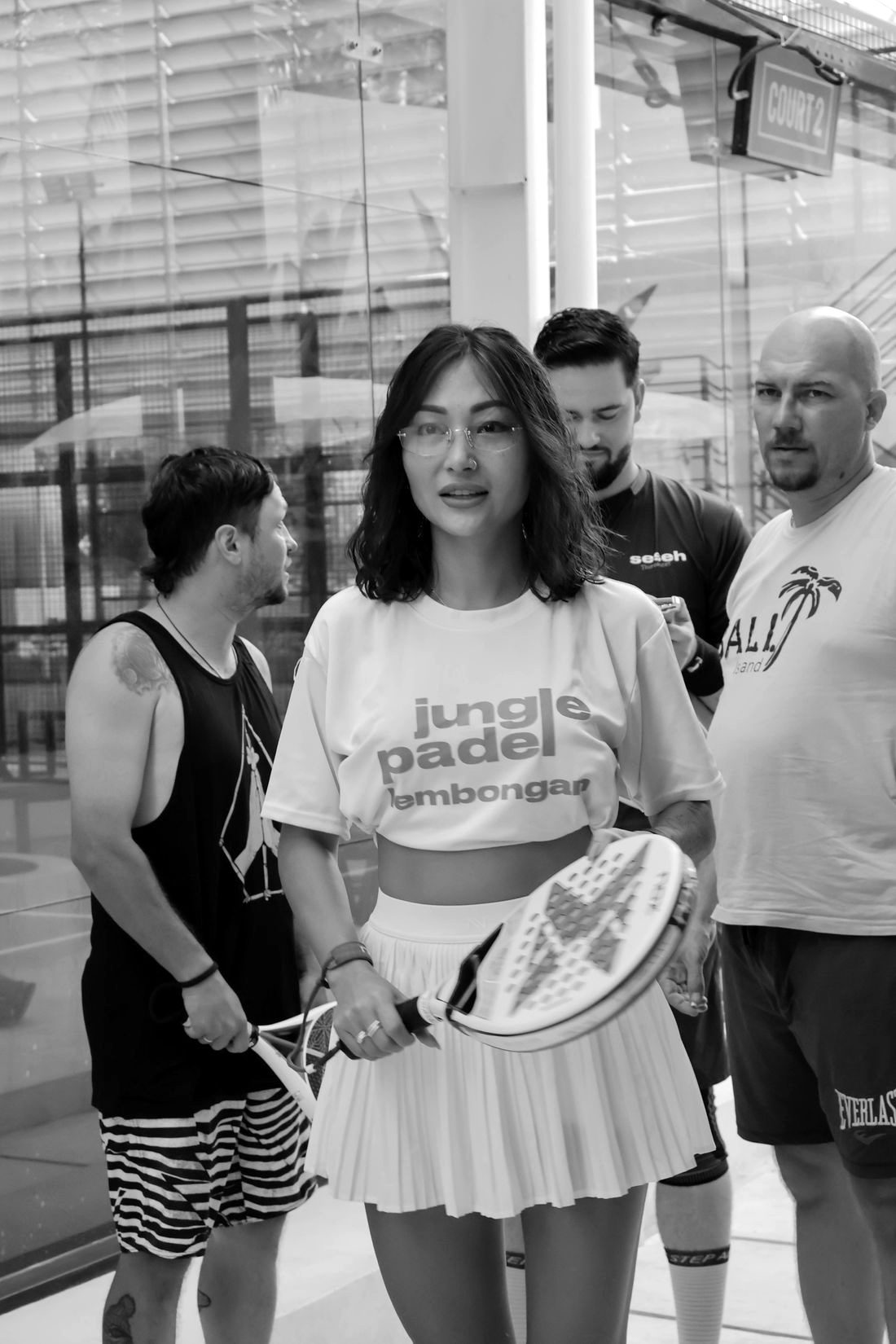 A group of adults playing padel indoors